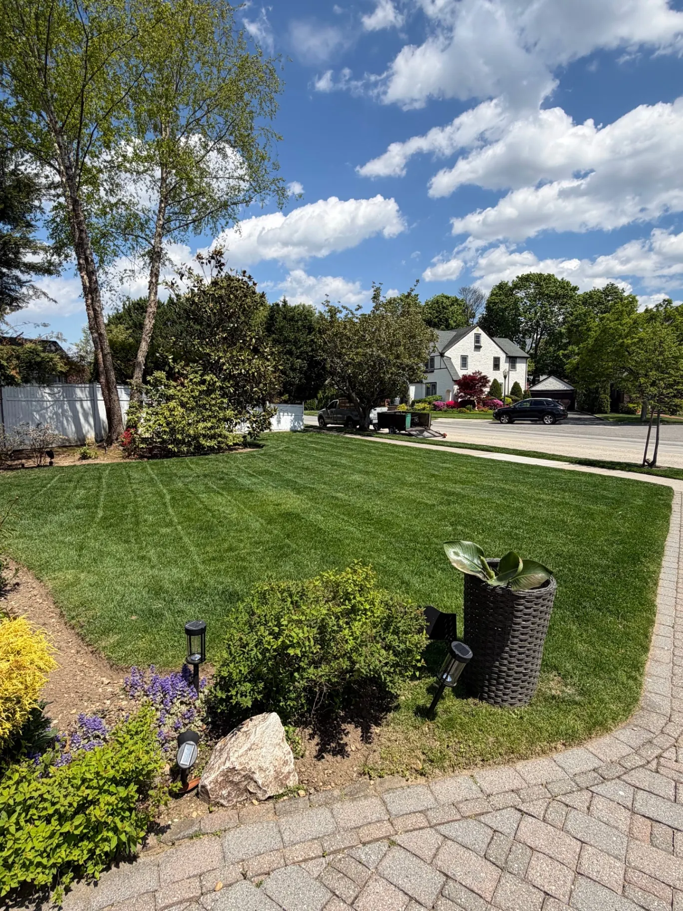 Healthy green lawn maintained by Greatness Landscaping & Construction under open skies